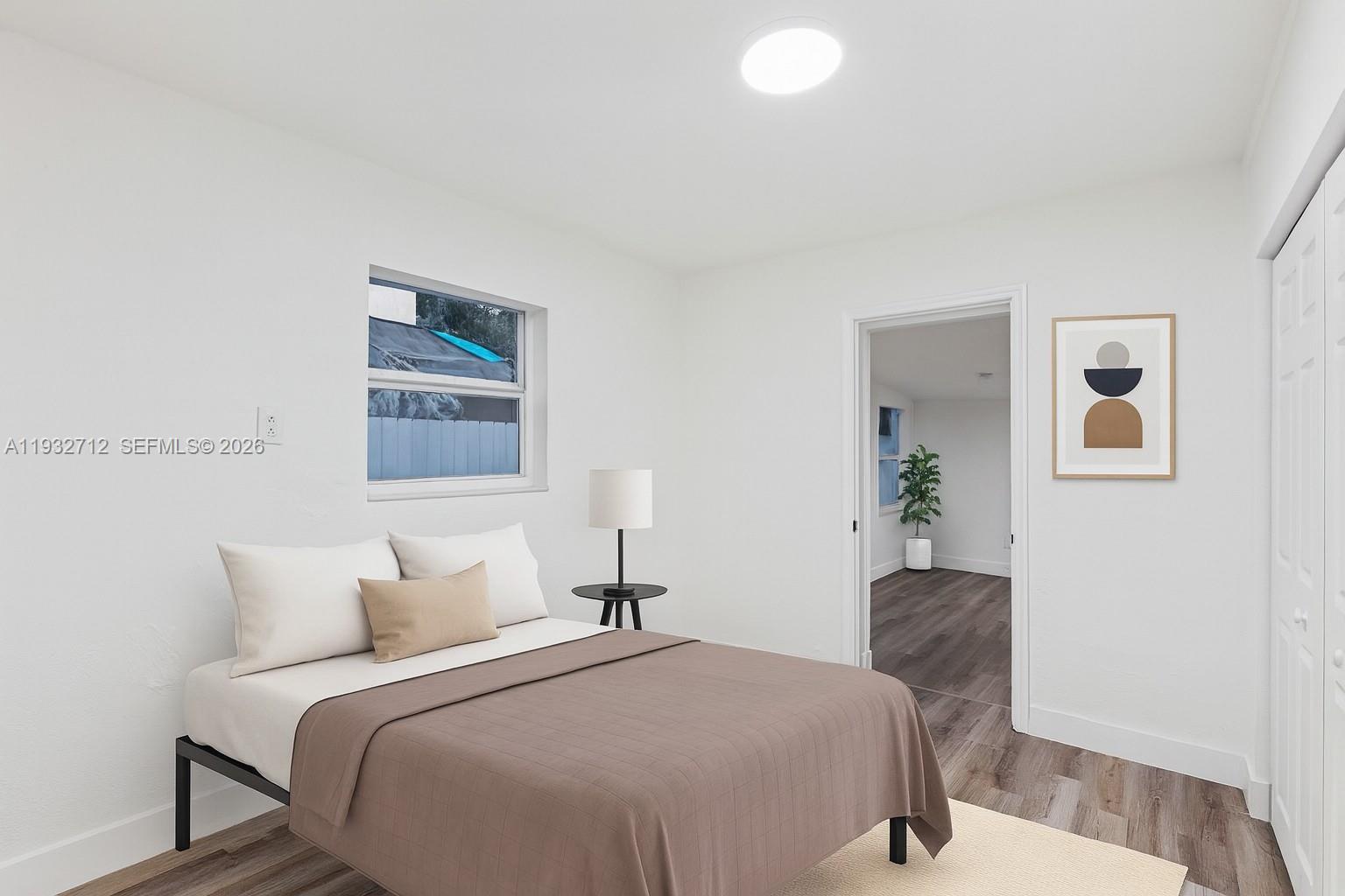 724 Burlington Street Opa-Locka, FL 33054 - Photo 8 of 15 a bedroom with bed and painting on the wall