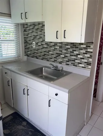 a kitchen with a sink and a window