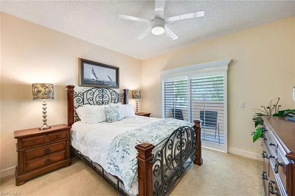 a bedroom with a bed and a ceiling fan