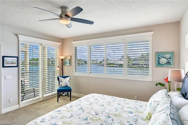 a bedroom that has a bed and a chair in it