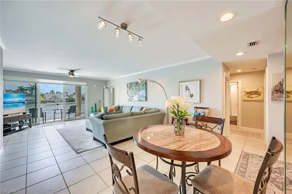a living room with furniture and a dining table