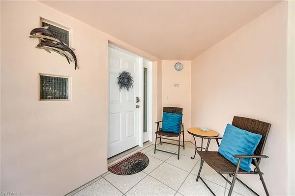 a view of a livingroom with furniture and a potted plant
