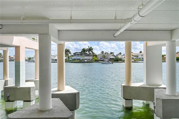 a front view of a house with lake and outdoor seating
