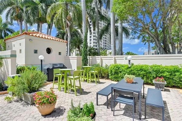 a view of an chairs and table in backyard