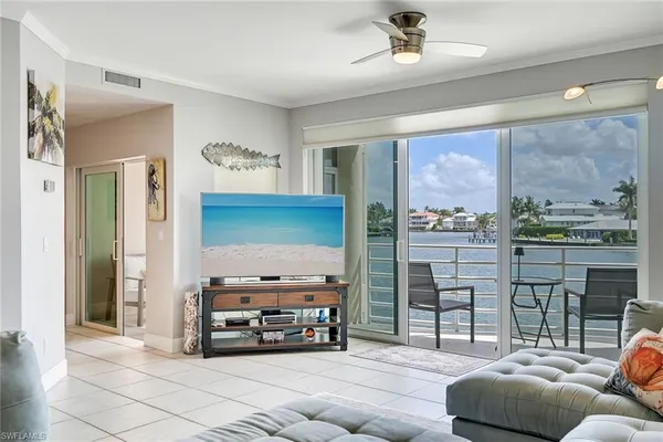 a living room with furniture and a floor to ceiling window