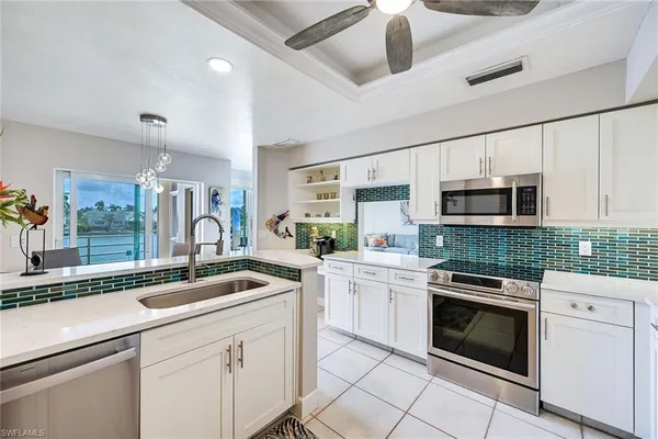 a kitchen with stainless steel appliances granite countertop a sink and cabinets