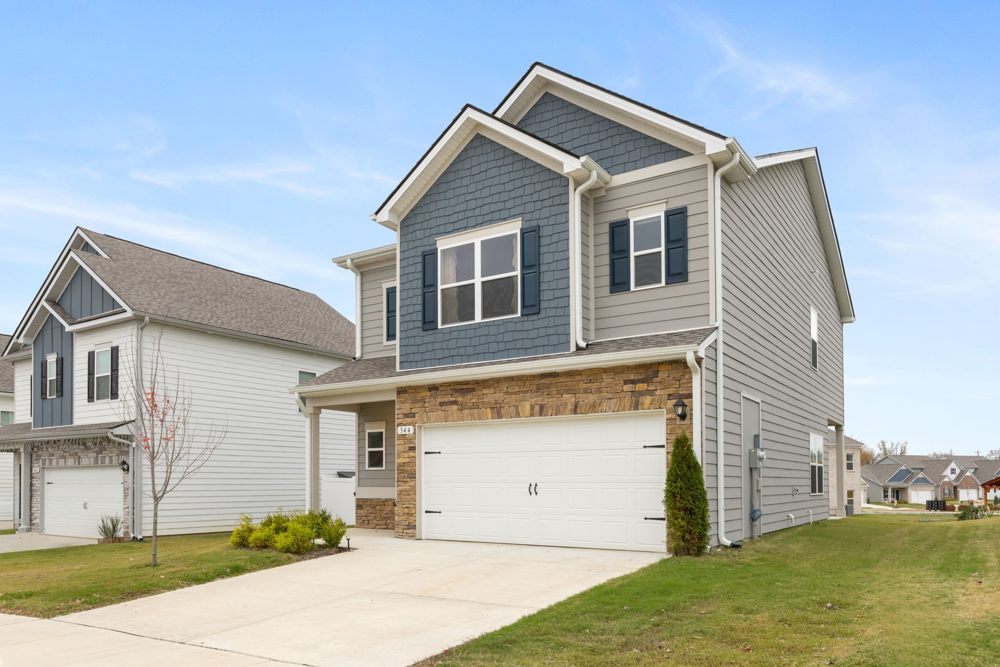344 Winston Way Gallatin, TN 37066 - Photo 2 of 23 a view of a house with a yard and garage