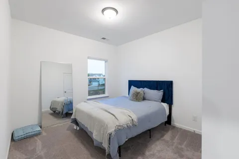 a bedroom with a bed and window