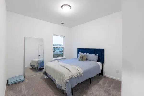 a bedroom with a bed and window
