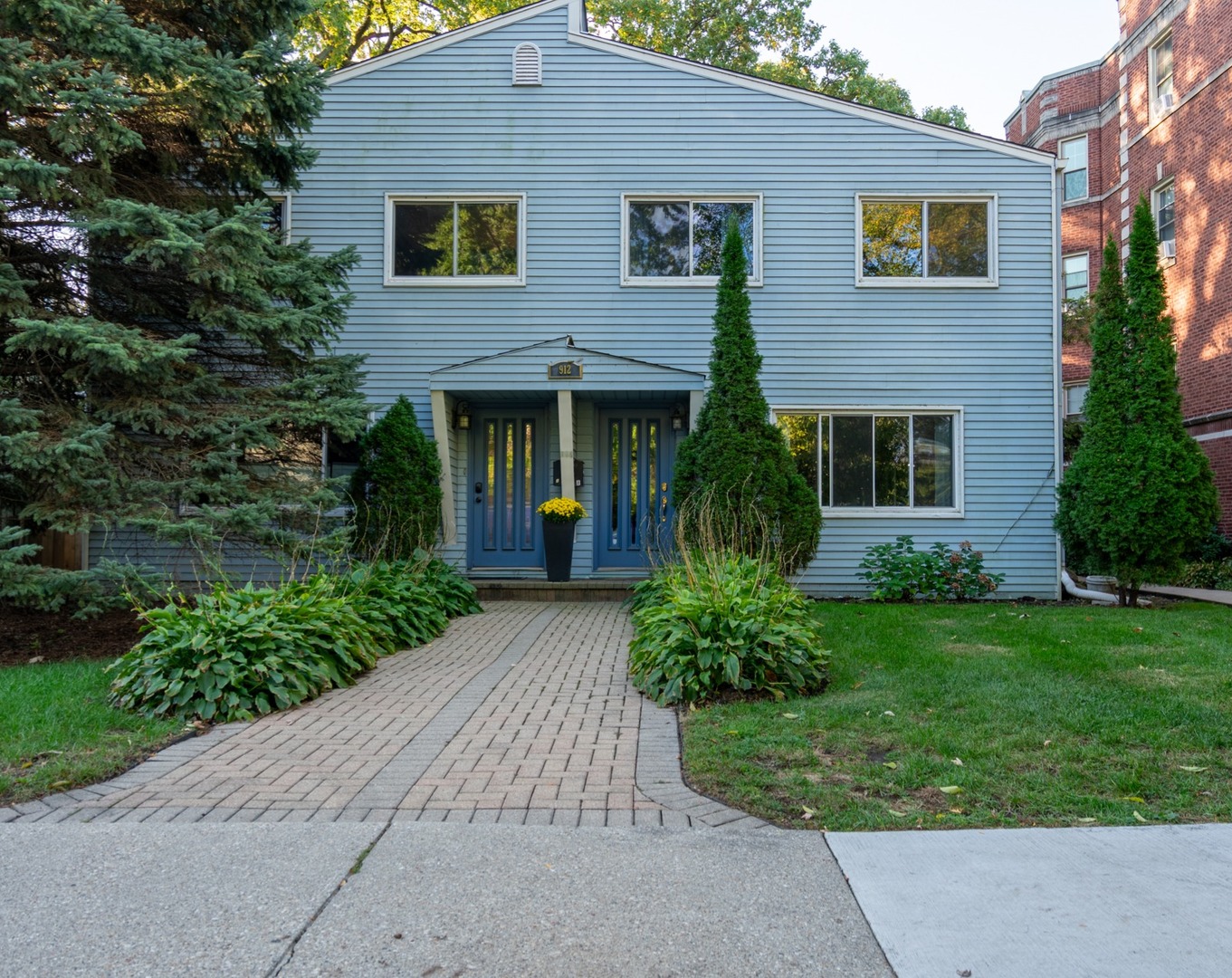 a view of a house with garden and plants