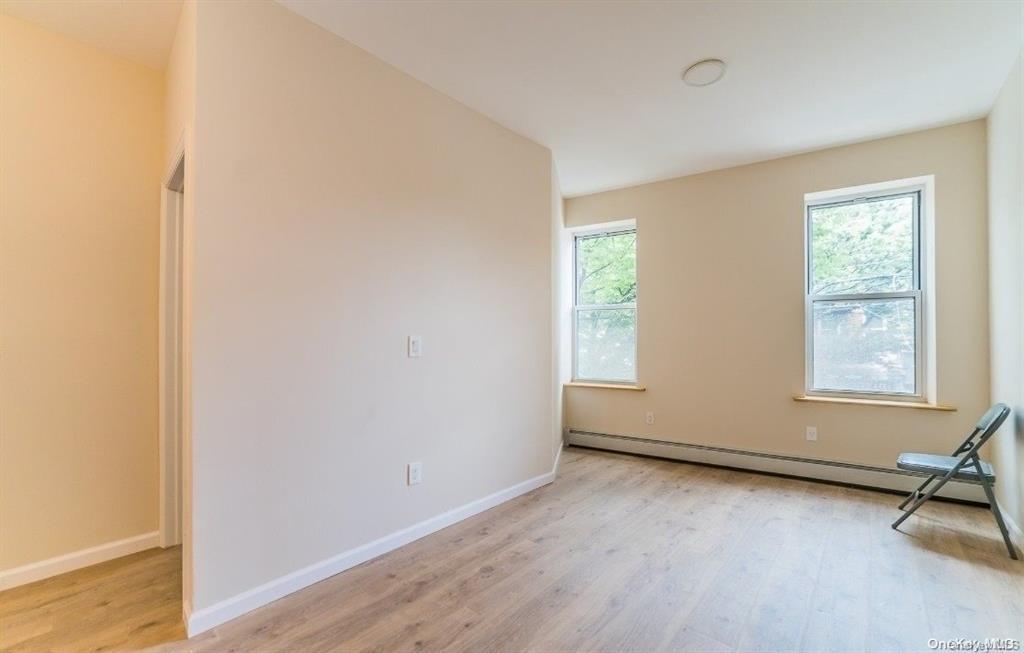3434 Fulton Street Brooklyn, NY 11208 - Photo 5 of 11 an empty room with a window