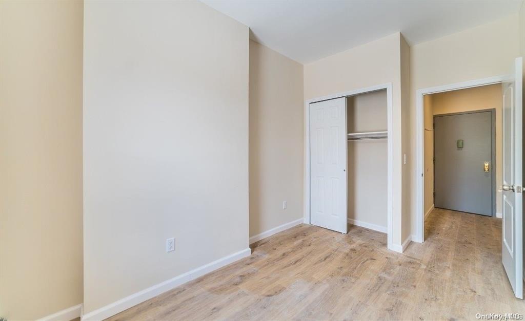 3434 Fulton Street Brooklyn, NY 11208 - Photo 8 of 11 a view of hallway with closet and wooden floor