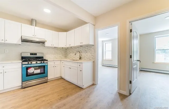 a kitchen with stainless steel appliances a stove a sink and a refrigerator