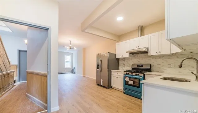 a kitchen with stainless steel appliances a refrigerator stove and sink