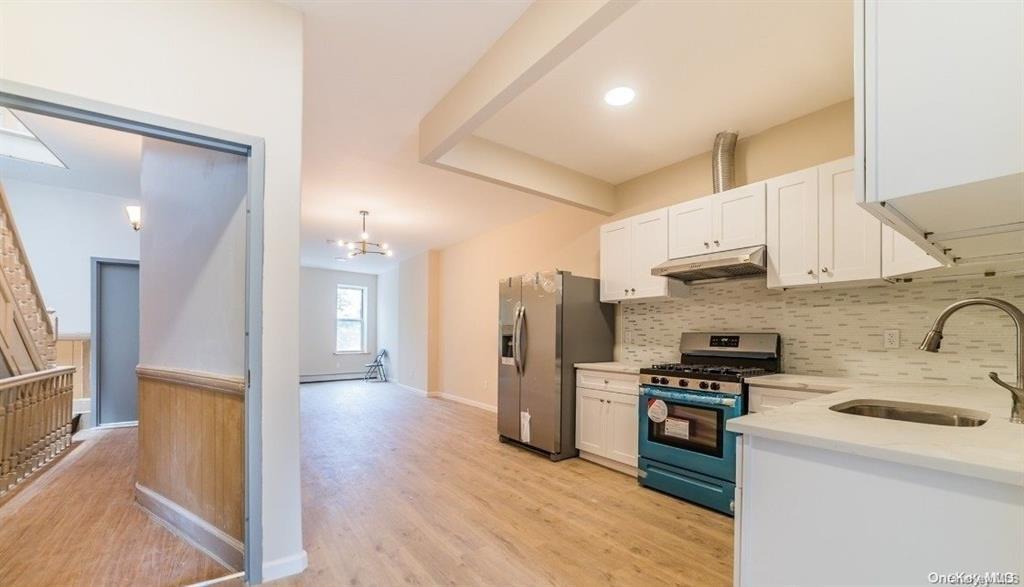 3434 Fulton Street Brooklyn, NY 11208 - Photo 10 of 11 a kitchen with stainless steel appliances a refrigerator stove and sink