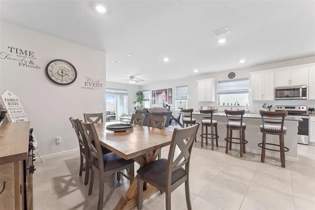 a kitchen with stainless steel appliances kitchen island granite countertop a stove a sink a refrigerator and a refrigerator