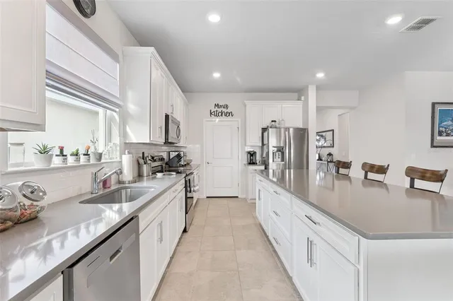 a view of a hallway that has a bed and dresser