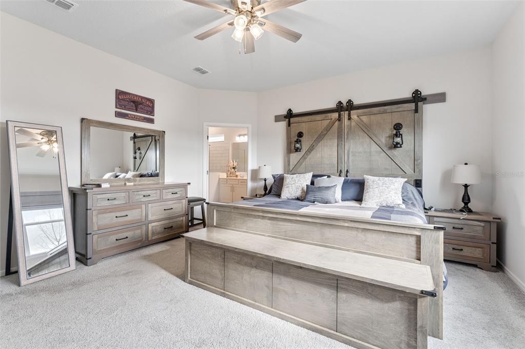 1989 Spring Shower Circle Kissimmee, FL 34744 - Photo 21 of 63 a view of a hallway that has a bed and dresser