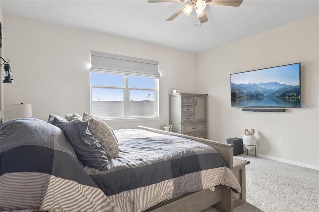 1989 Spring Shower Circle Kissimmee, FL 34744 - Photo 22 of 63 a bedroom with a large bed and a window