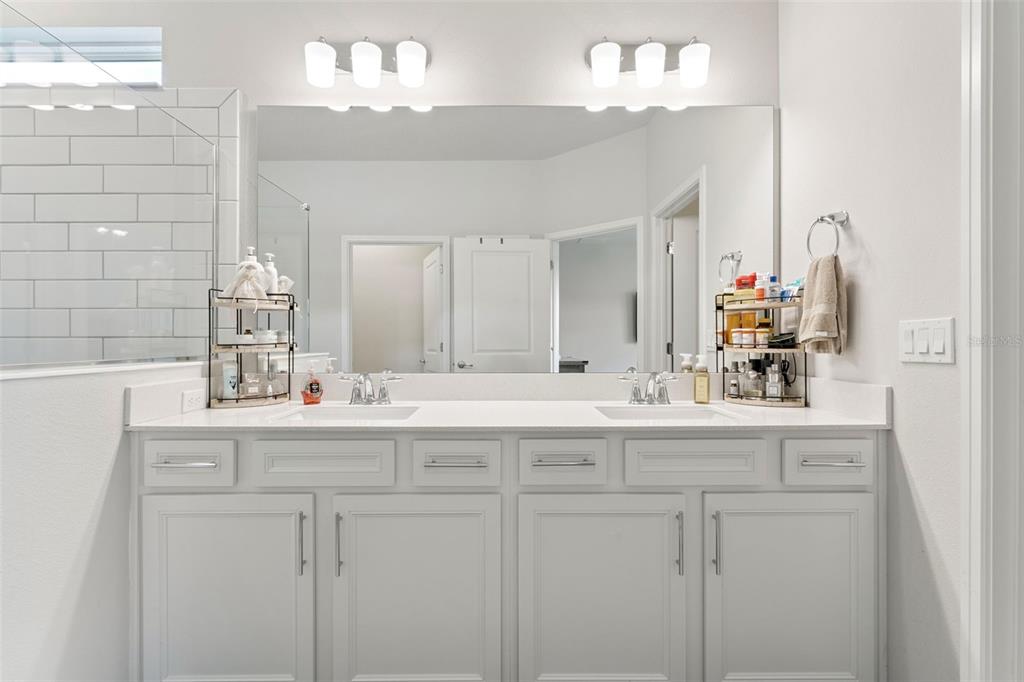 1989 Spring Shower Circle Kissimmee, FL 34744 - Photo 25 of 63 a bathroom with a sink vanity granite and a mirror