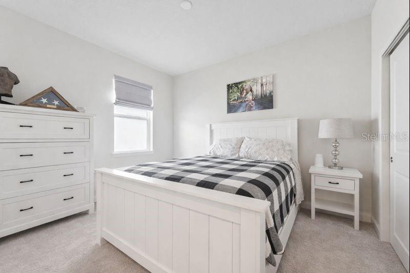 1989 Spring Shower Circle Kissimmee, FL 34744 - Photo 28 of 63 a bedroom with a bed and a window