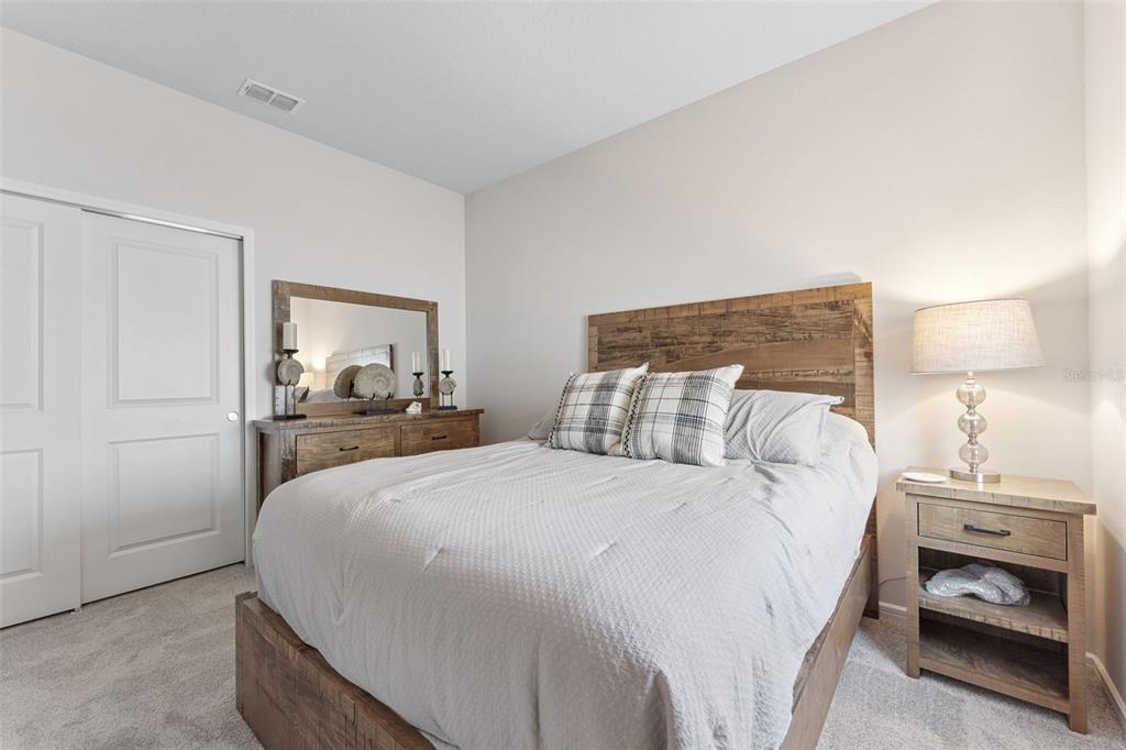 1989 Spring Shower Circle Kissimmee, FL 34744 - Photo 30 of 63 a bedroom with a bed and a lamp