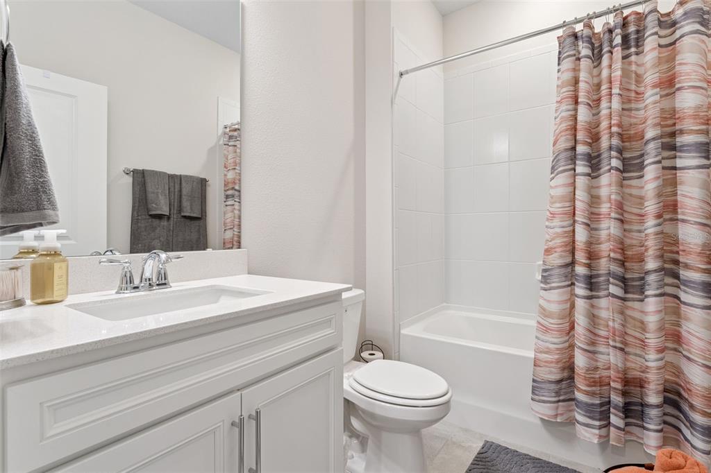 1989 Spring Shower Circle Kissimmee, FL 34744 - Photo 31 of 63 a bathroom with a sink a toilet and a mirror