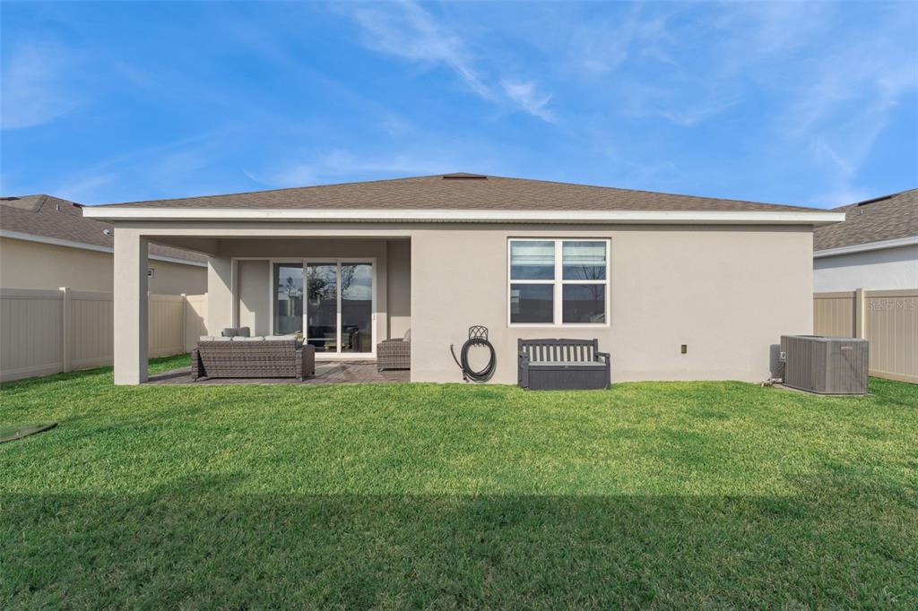 1989 Spring Shower Circle Kissimmee, FL 34744 - Photo 37 of 63 a house view with a sitting space and garden