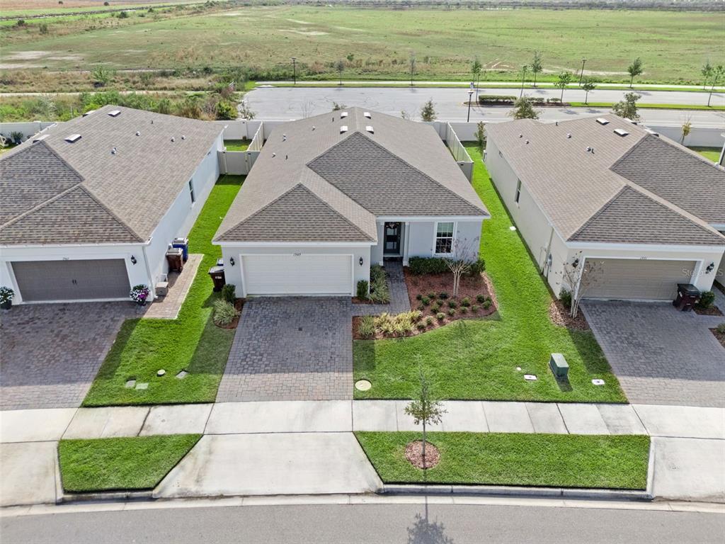 1989 Spring Shower Circle Kissimmee, FL 34744 - Photo 39 of 63 an aerial view of a house with a yard and a garage