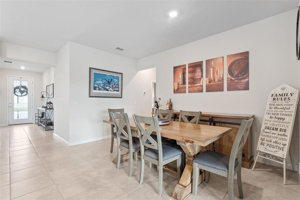 1989 Spring Shower Circle Kissimmee, FL 34744 - Photo 8 of 63 a view of a dining room and livingroom furniture wooden floor a rug and a painting