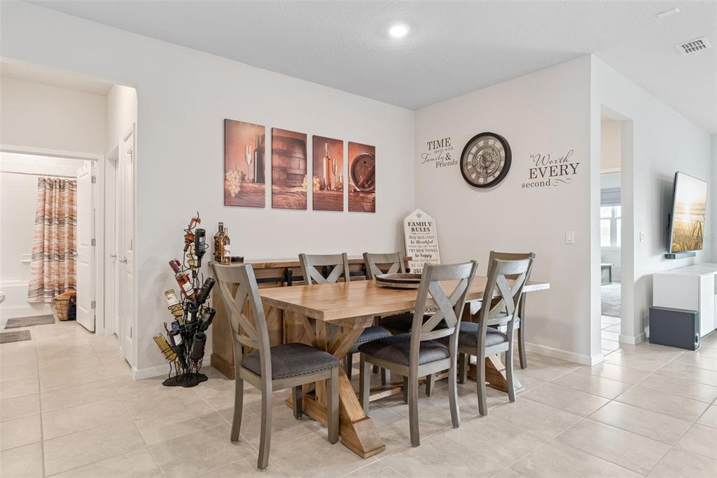 1989 Spring Shower Circle Kissimmee, FL 34744 - Photo 9 of 63 a view of a dining room and kitchen with furniture window and wooden floor