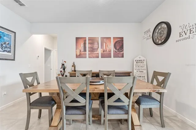 a living room with furniture ceiling fan and a window