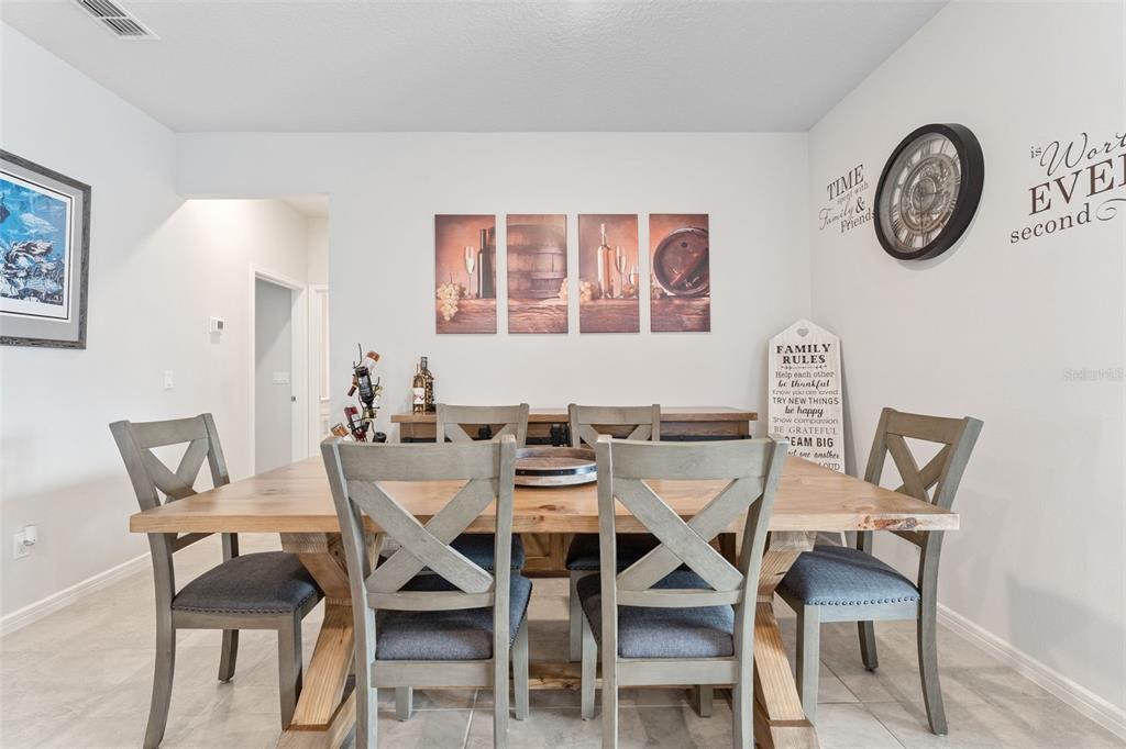1989 Spring Shower Circle Kissimmee, FL 34744 - Photo 10 of 63 a view of a dining room with furniture and a table