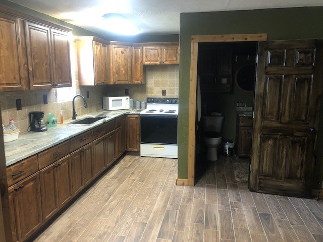 251 East Ranch Road 2169 Junction, TX 76849 - Photo 34 of 43 a kitchen with stainless steel appliances granite countertop a refrigerator and a sink