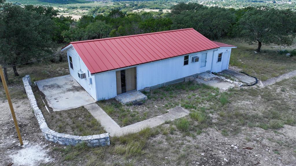 251 East Ranch Road 2169 Junction, TX 76849 - Photo 7 of 43 a view of a small house in the forest