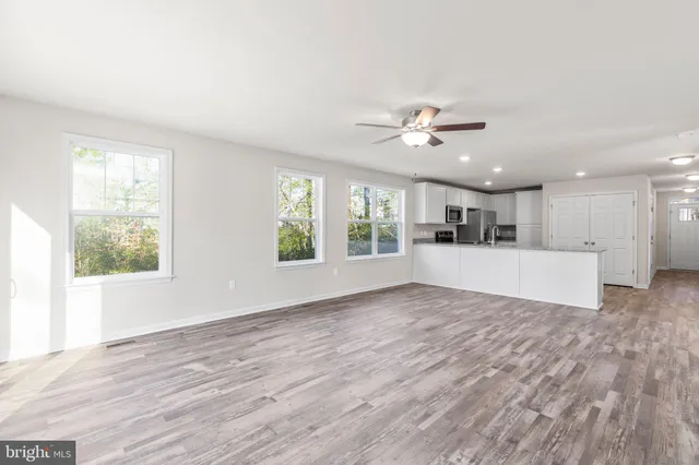 a view of kitchen and hall with wooden floor