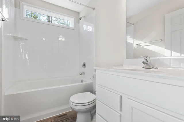 a bathroom with a sink a toilet and a bathtub