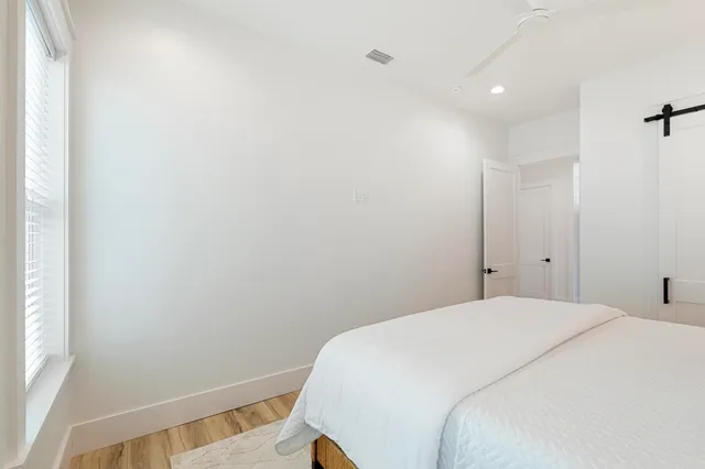 a bedroom with a bed and a window