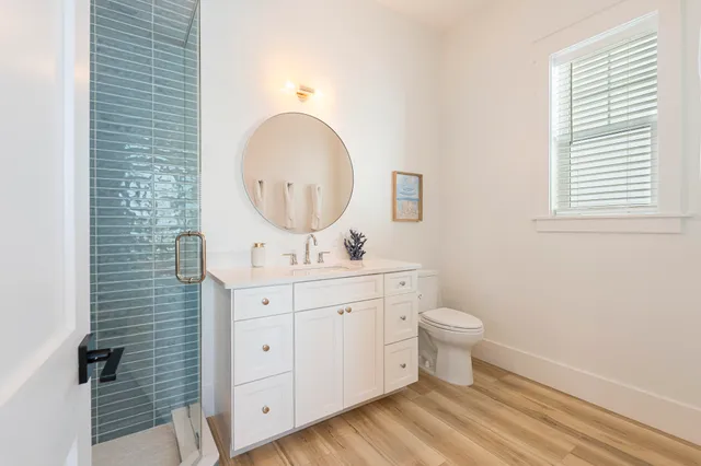 a bathroom with a double vanity sink mirror and shower