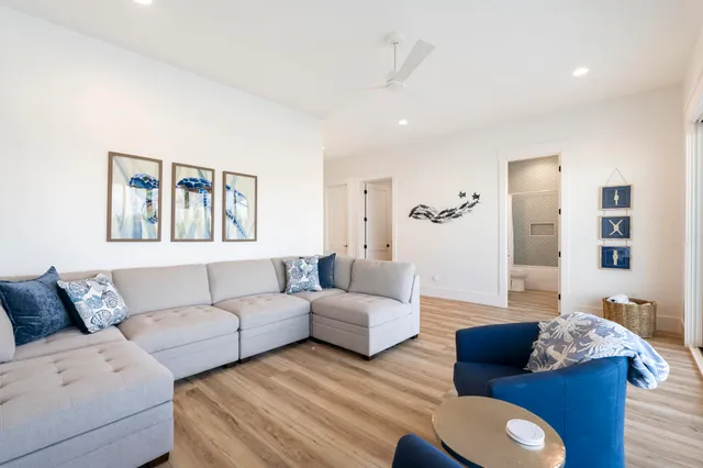a bedroom with a bed and a flat tv screen on dresser
