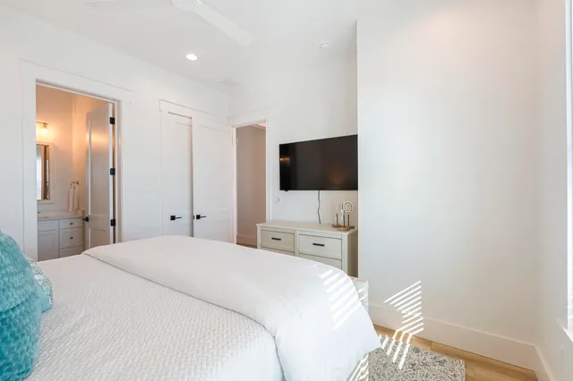 a bathroom with a toilet a sink a glass door a shower and vanity