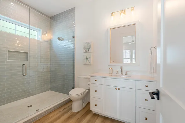 a utility room with wooden floor washer and dryer
