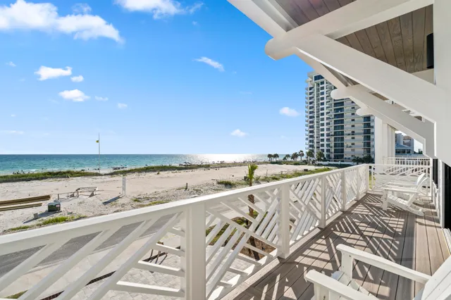 a dining room with furniture potted plants and wooden floor