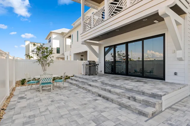 a view of a patio with table and chairs and potted plants