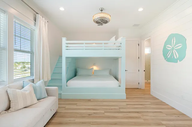 a bedroom with a large bed and a chandelier