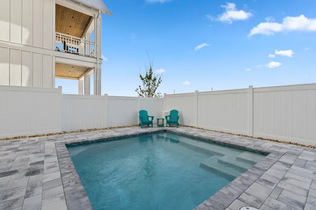 a kitchen with stainless steel appliances a dining table chairs stove and cabinets