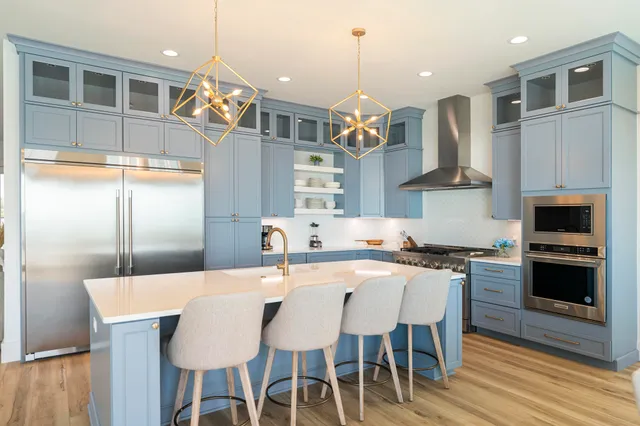 a view of a kitchen counter space a sink appliances and a window