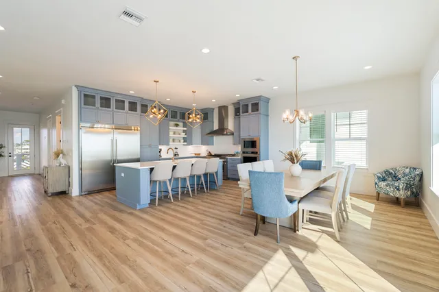 a living room with furniture a flat screen tv and a potted plant