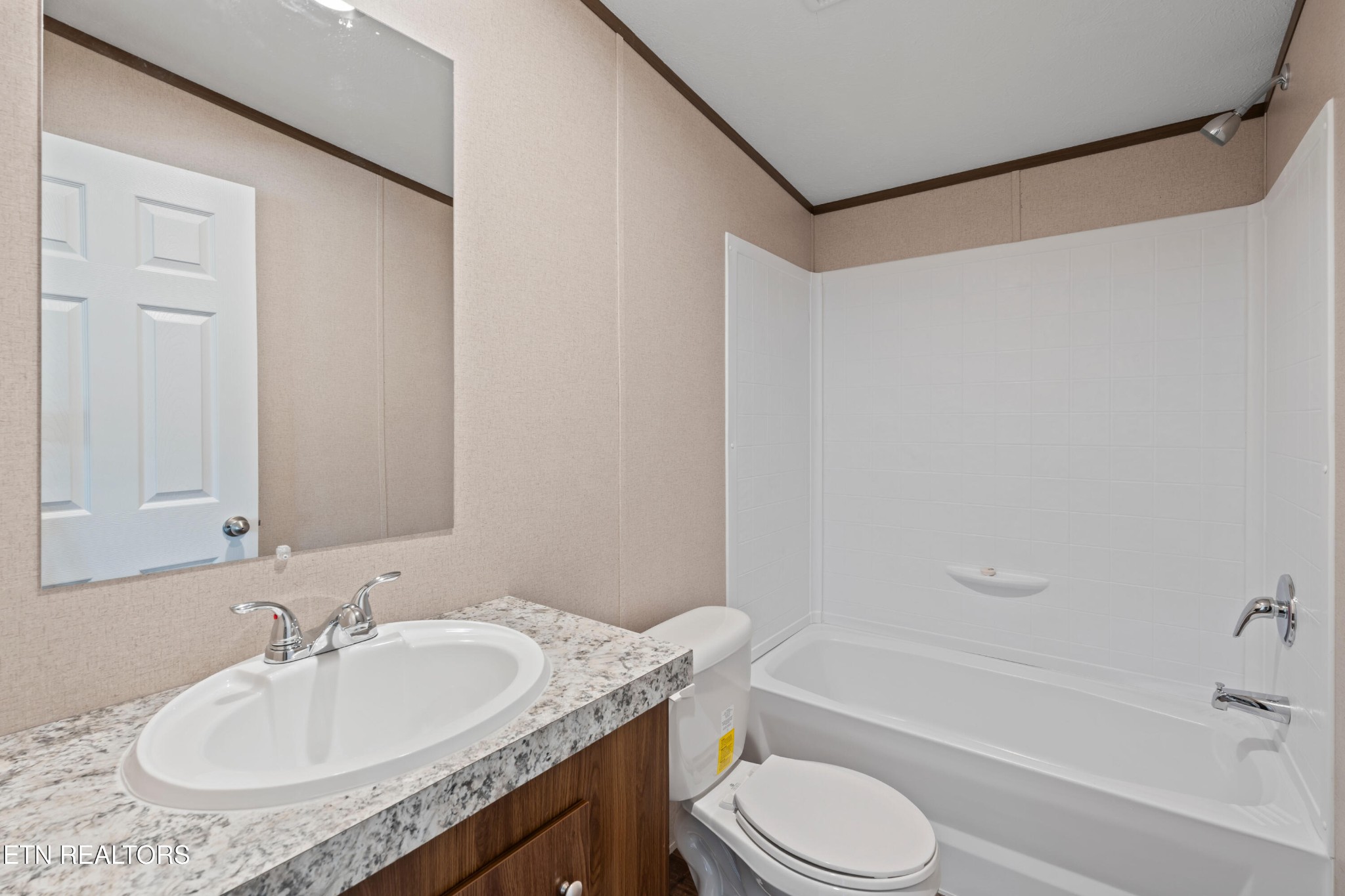 911 Summer Street Loudon, TN 37774 - Photo 16 of 25 a bathroom with a granite countertop sink toilet and shower