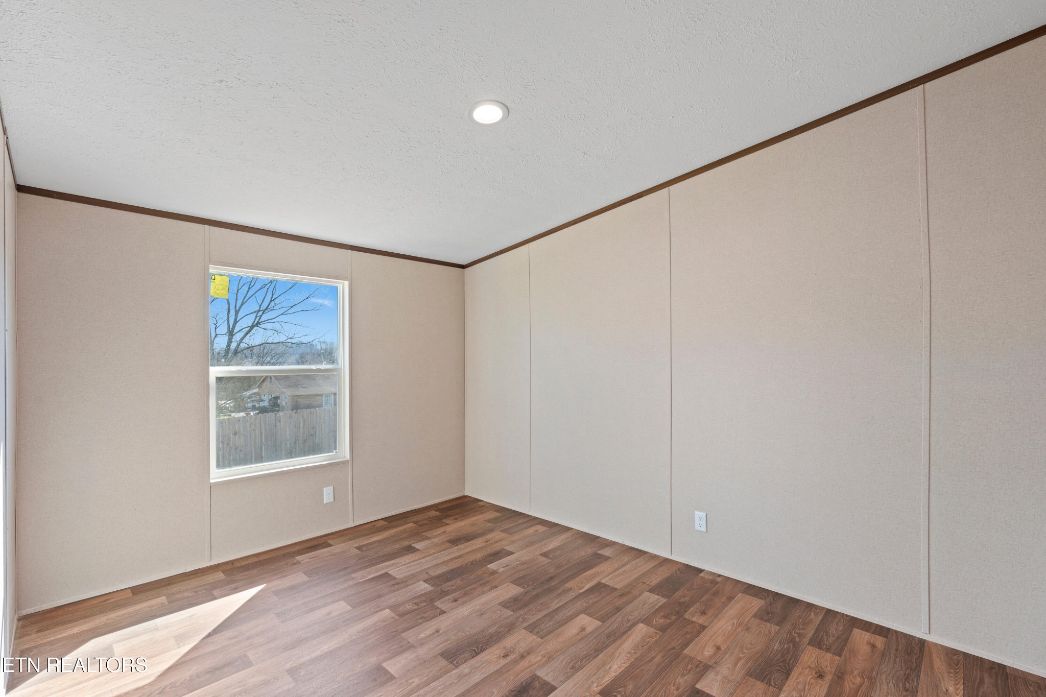 911 Summer Street Loudon, TN 37774 - Photo 17 of 25 a view of an empty room with window and wooden floor